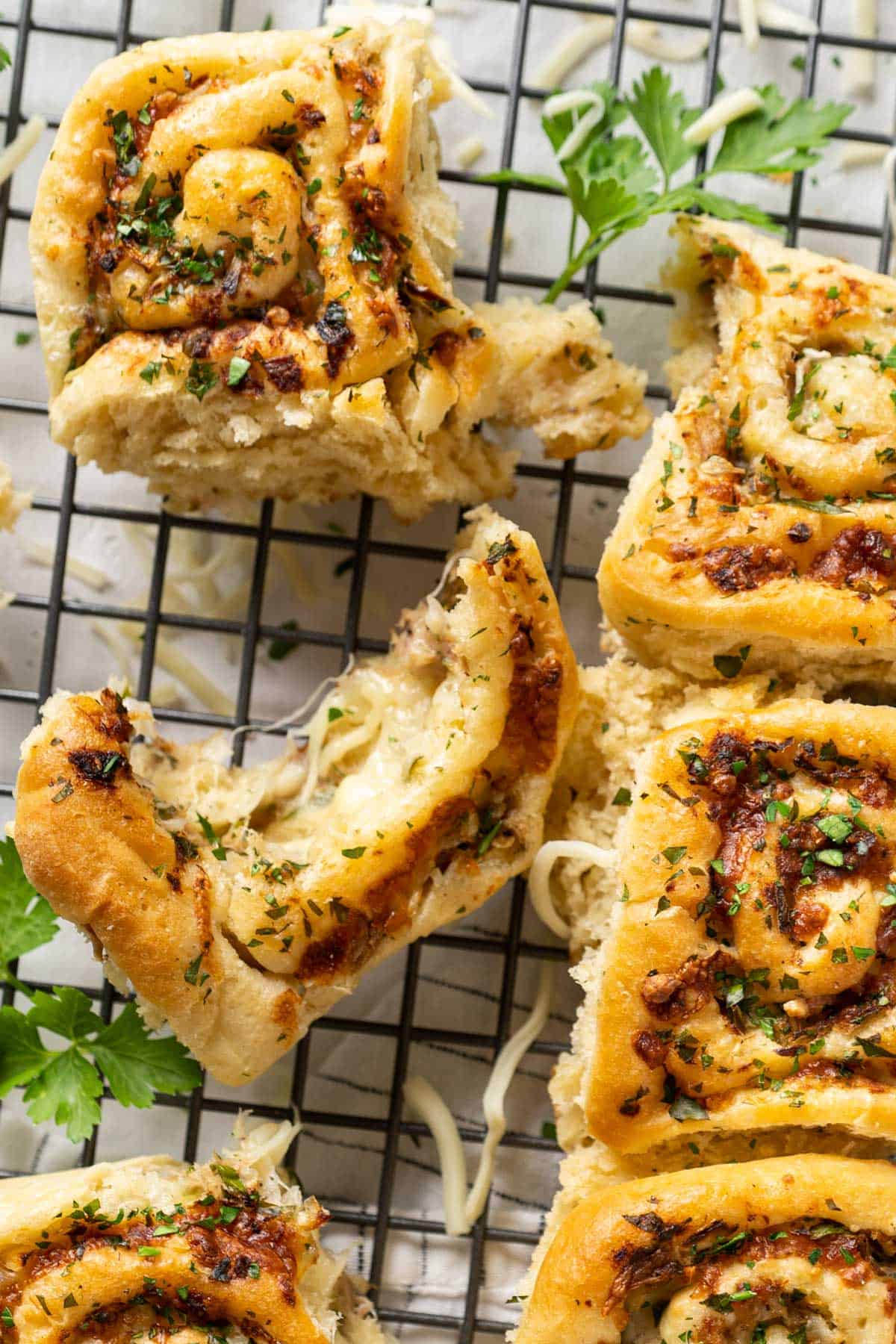 Half eaten tuna cheese rolls on a rack