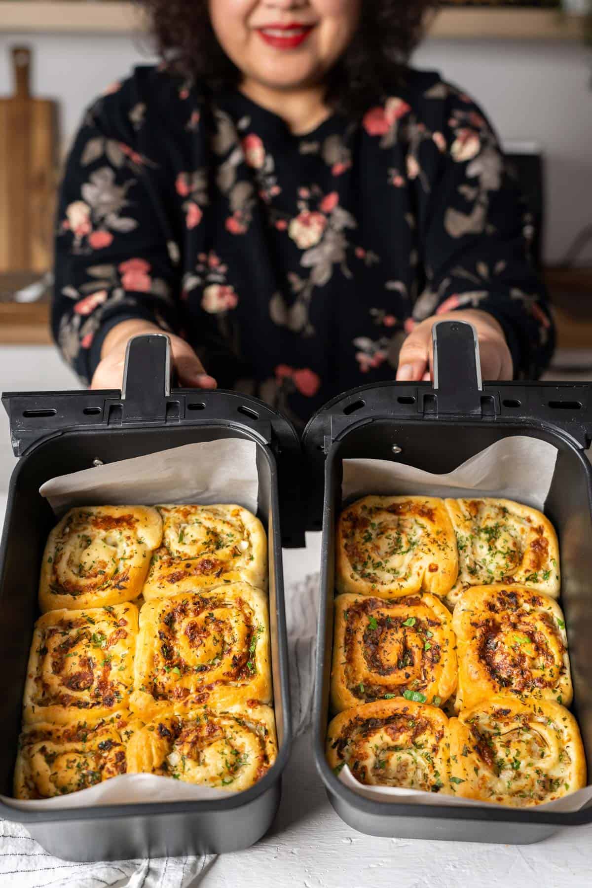 Showing cooked tuna cheese rolls in air fryer baskets