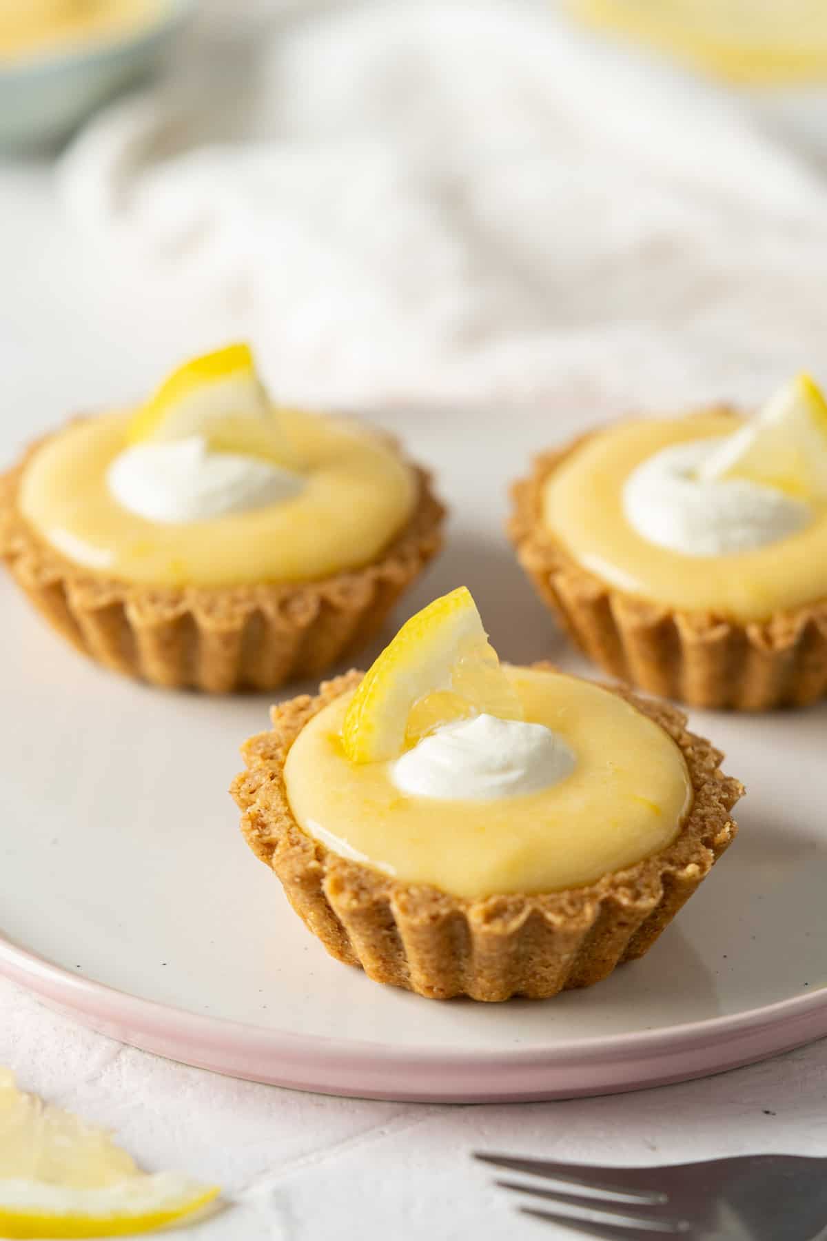 3 healthy lemon tarts on a plate