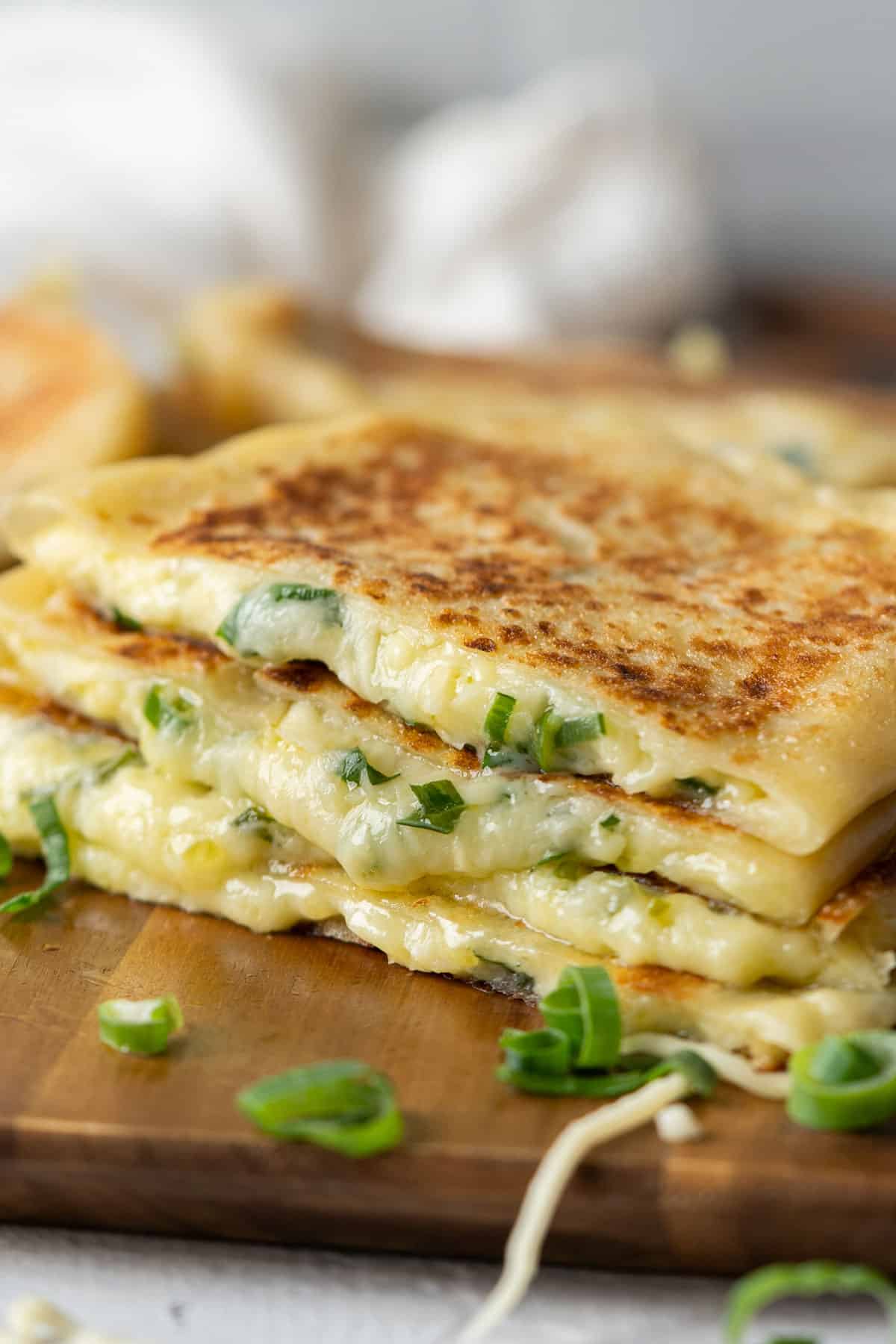 Cheese roti canai stacked on a board close up view