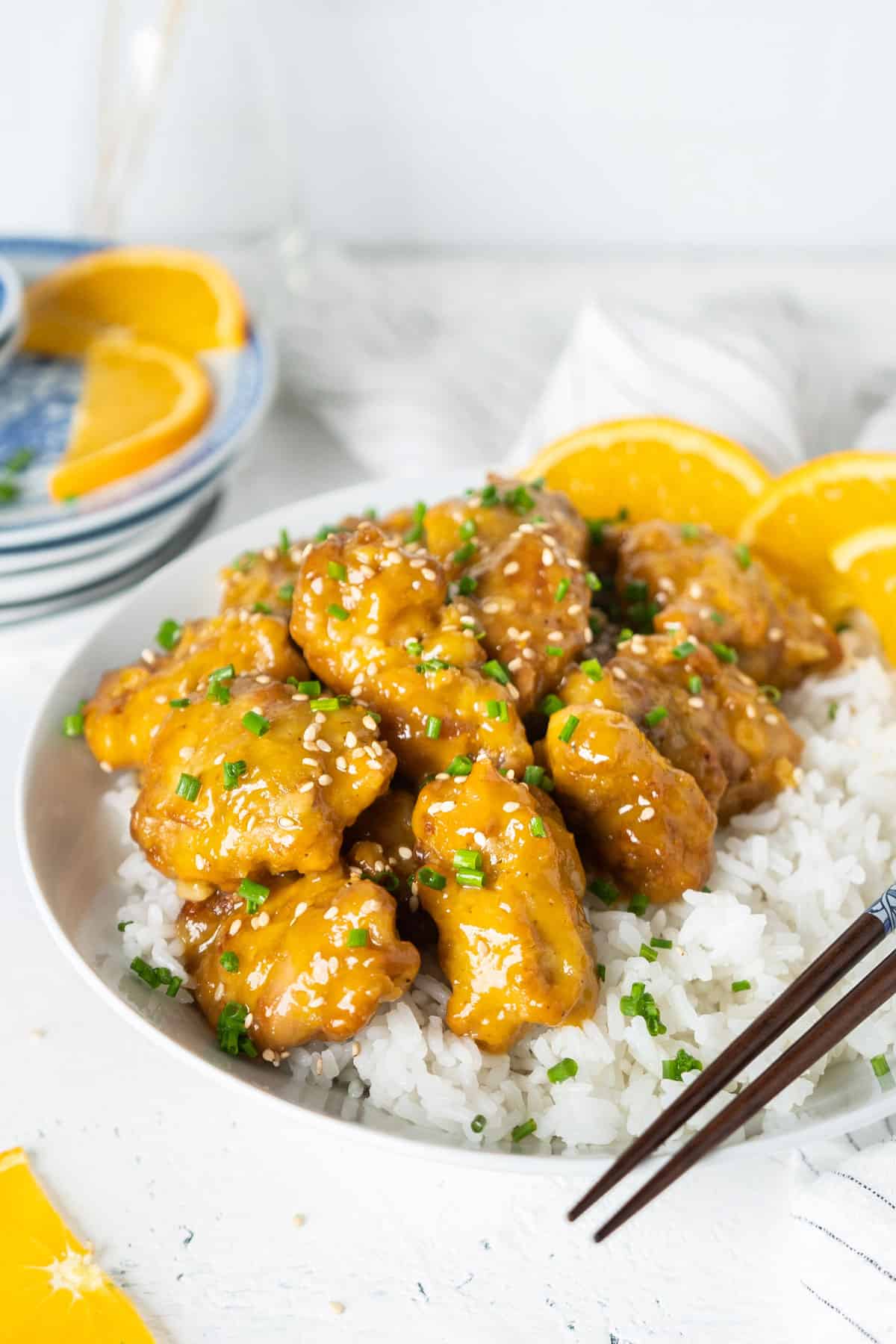 Air-fryer orange chicken with some rice in a bowl.