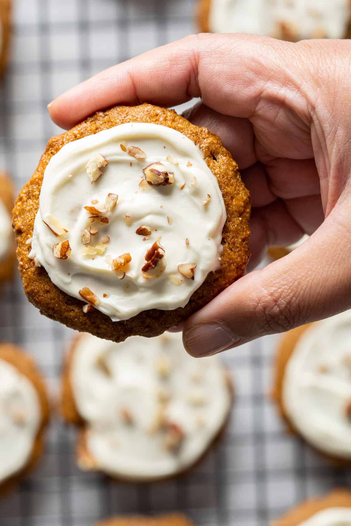 Holding a healthy carrot cake cookie.