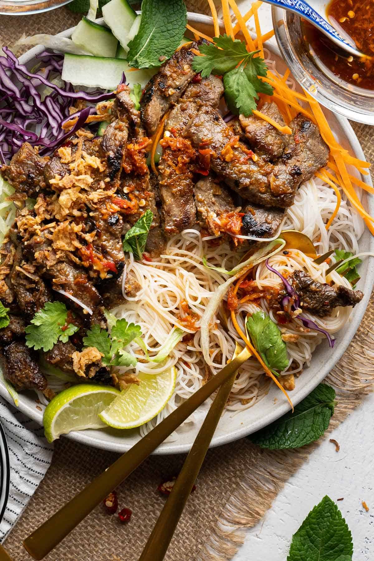 Half-eaten Vietnamese lemongrass beef noodles salad view from top.