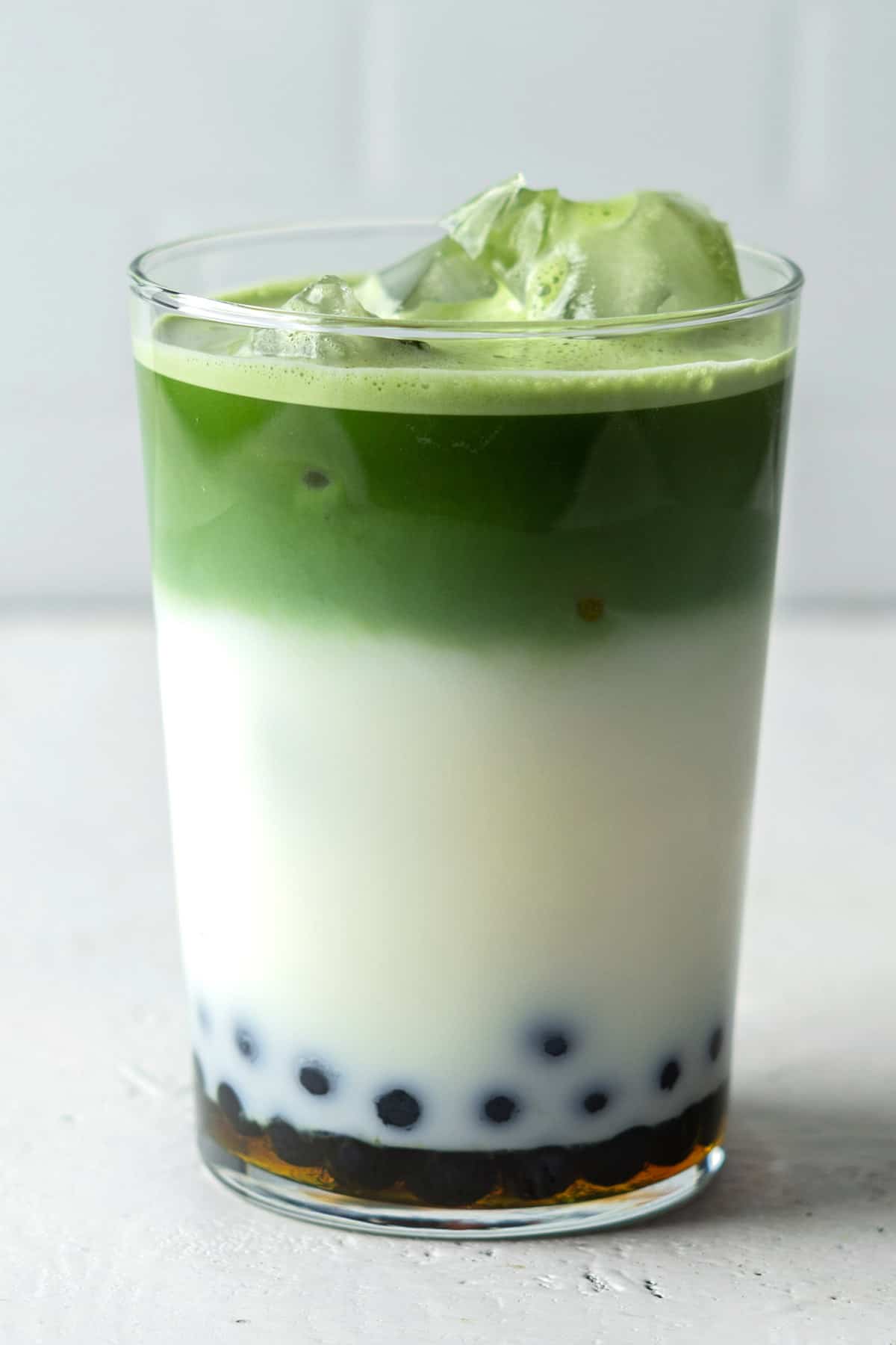 Matcha boba tea in a glass.