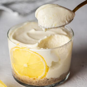 Spooning healthy no-bake lemon cheesecake cup.