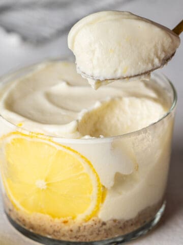 Spooning healthy no-bake lemon cheesecake cup.