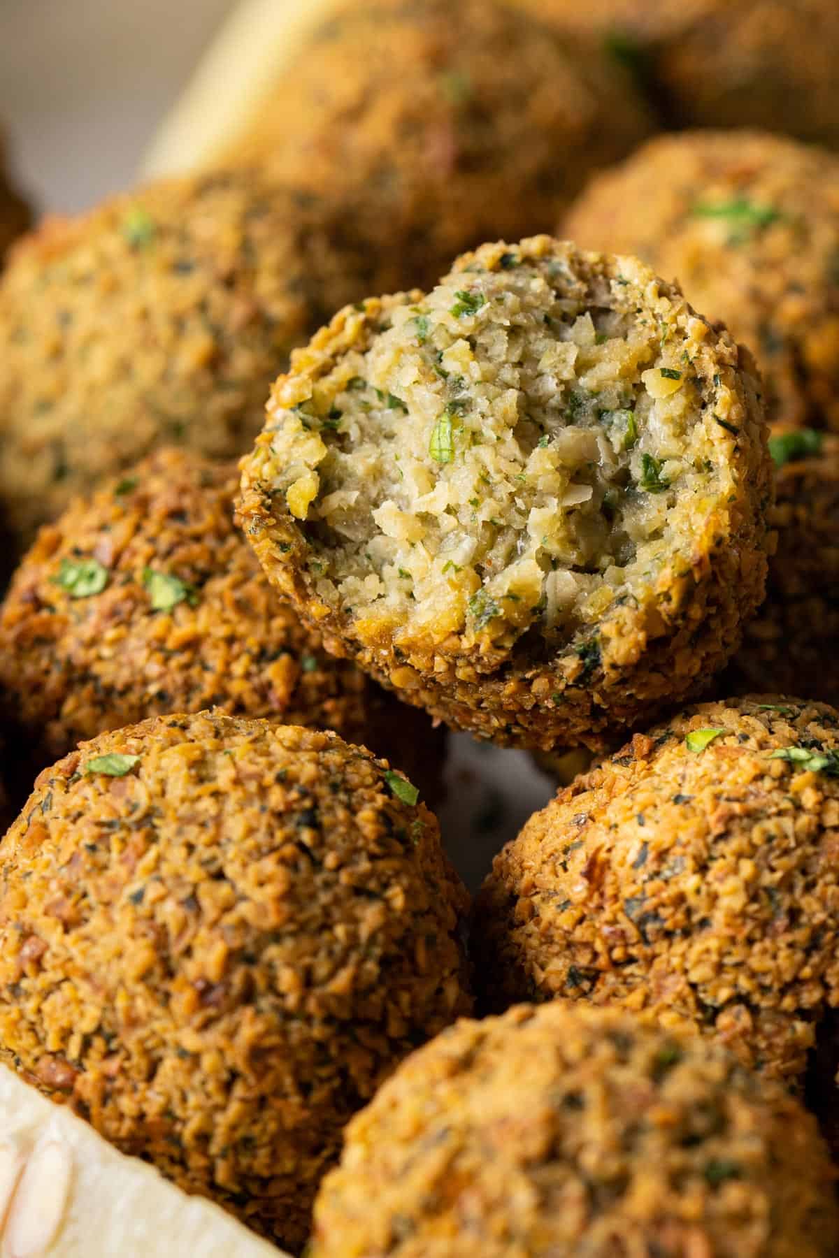 Showing the inside texture of a half-eaten falafel.