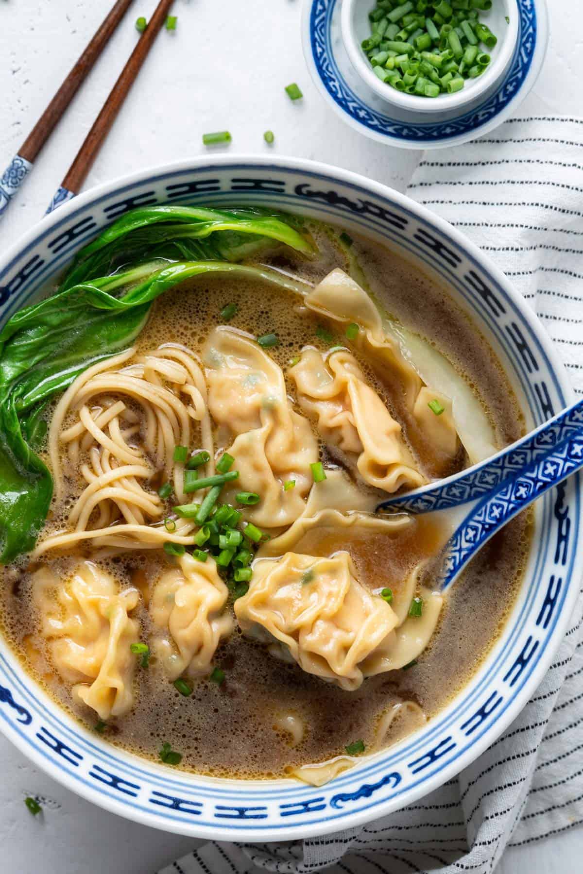 Wonton noodle soup in a bowl view from up.