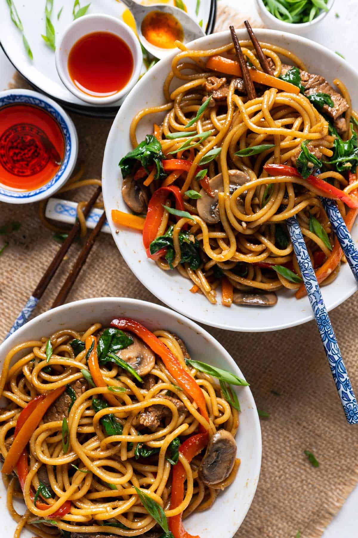 Lo mein noodles served in two small bowls.