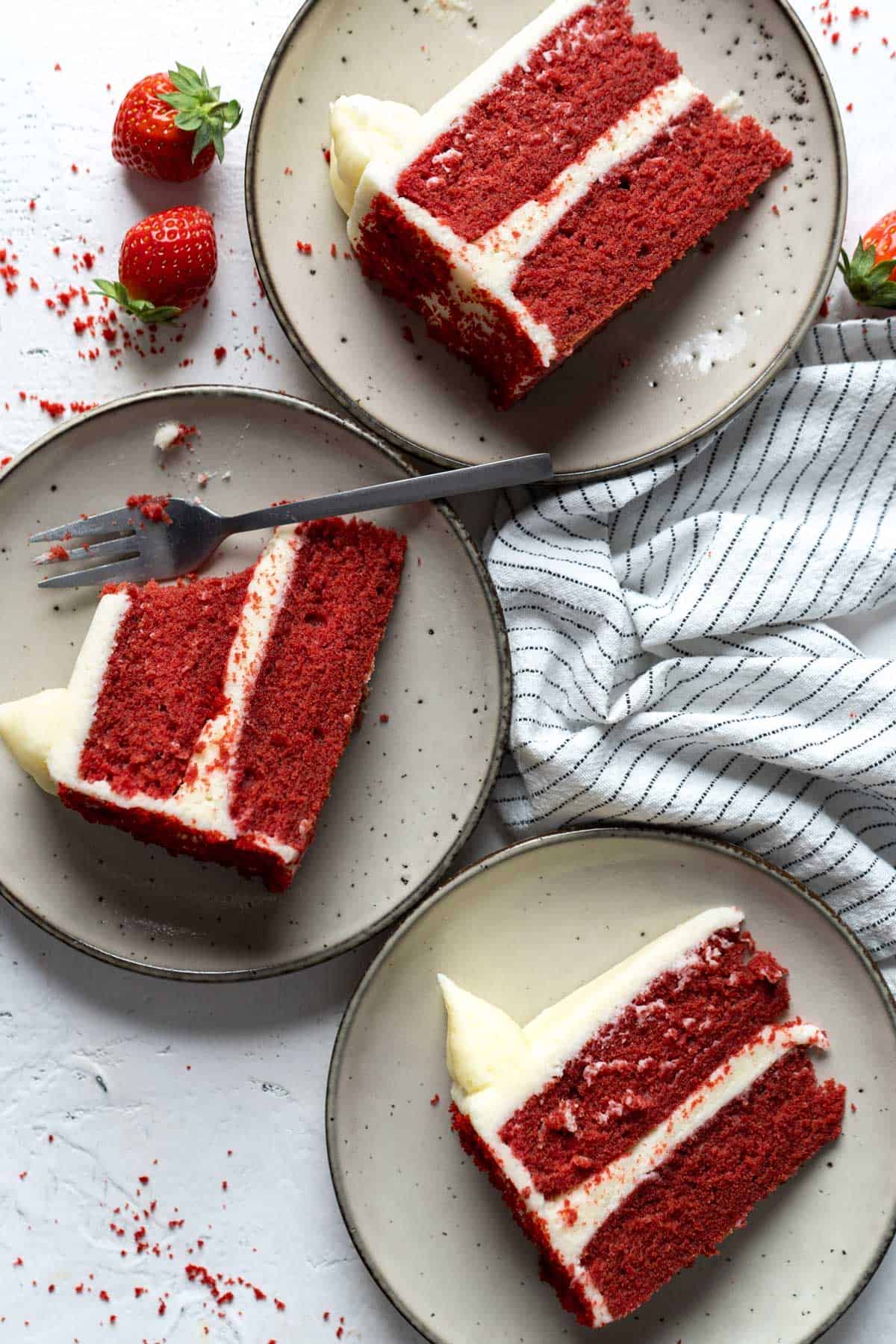 Slices of red velvet cake in individual plates.