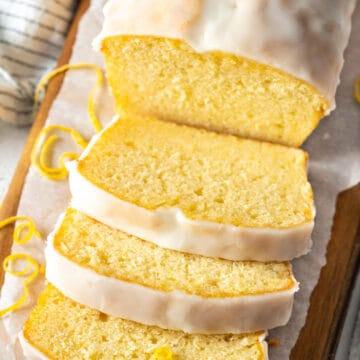 Slices of cake on a wooden cutting board.