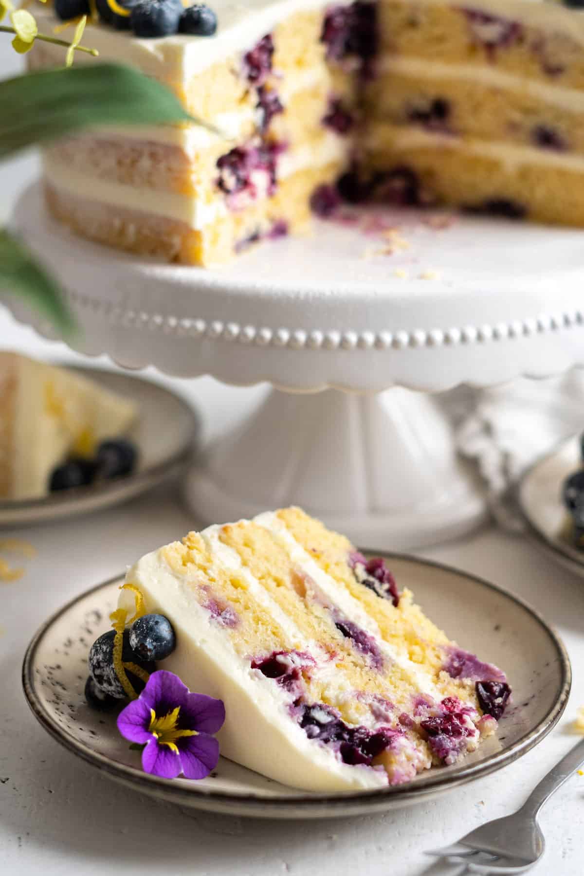 A slice of lemon blueberry cake in a plate.