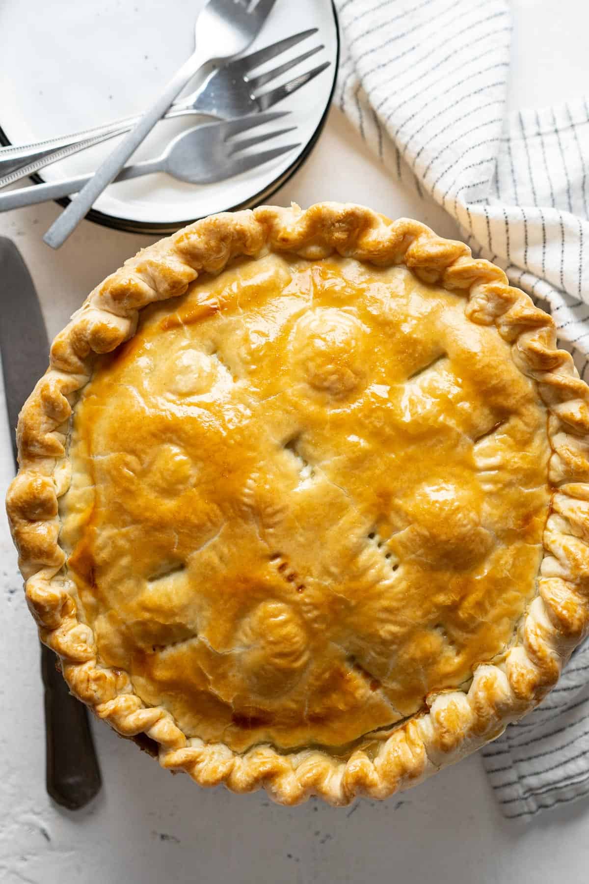 A whole pie on a cooling rack.