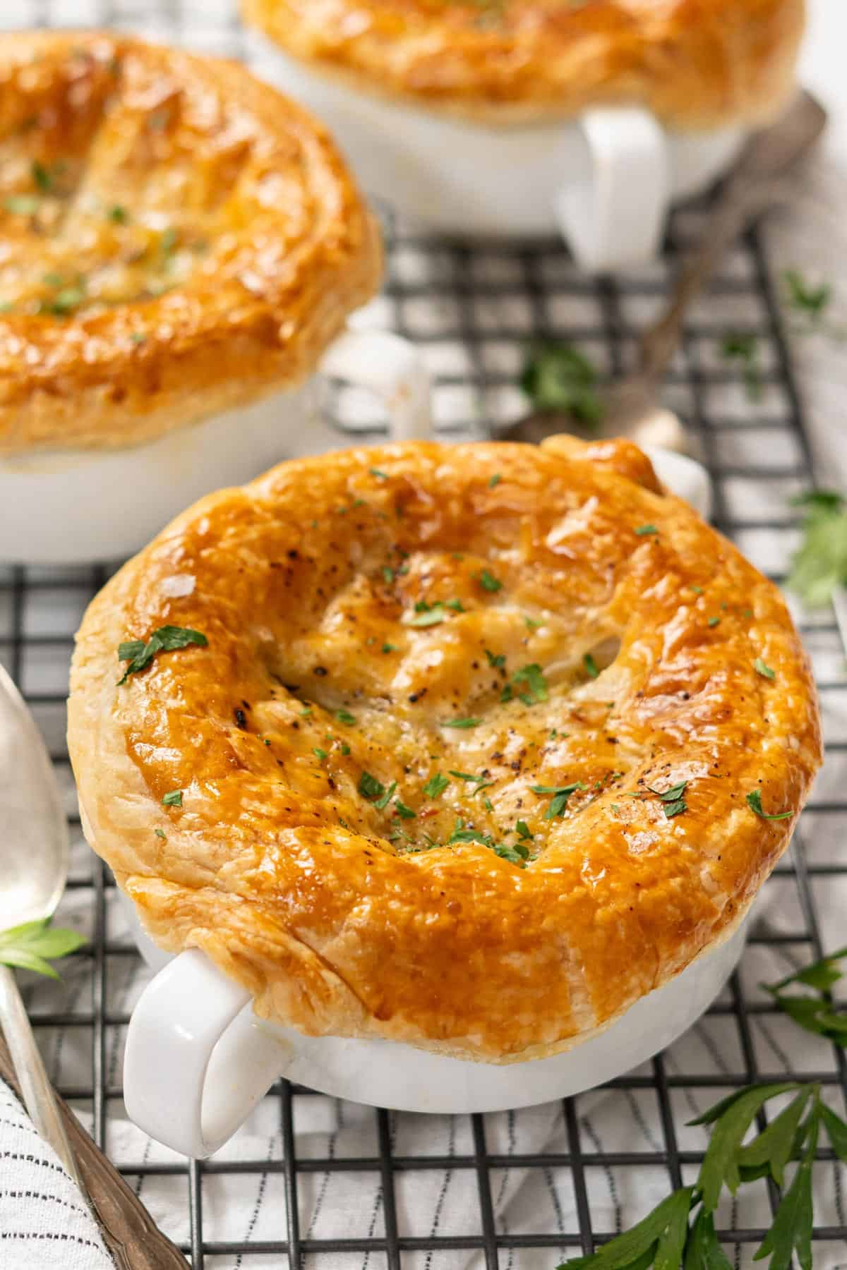 Bowls of mini chicken pot pies on a cooling rack.