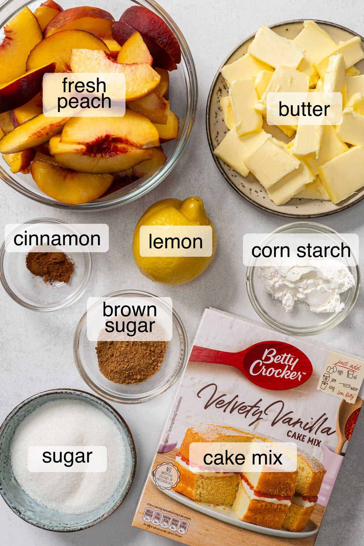 Ingredients to make peach cobbler with cake mix.