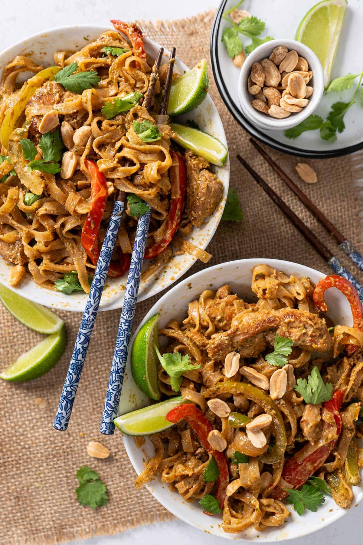 Peanut butter stir-fry noodles in two individual bowls.