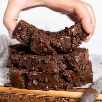 Picking up a slice of chocolate banana bread.