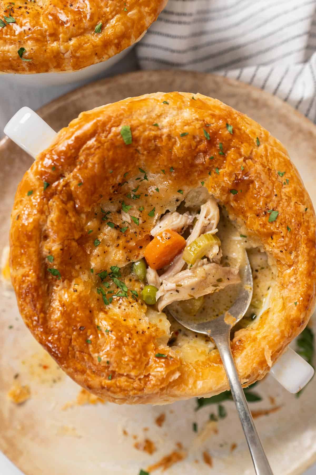 Spooning the filling of a chicken pot pie.