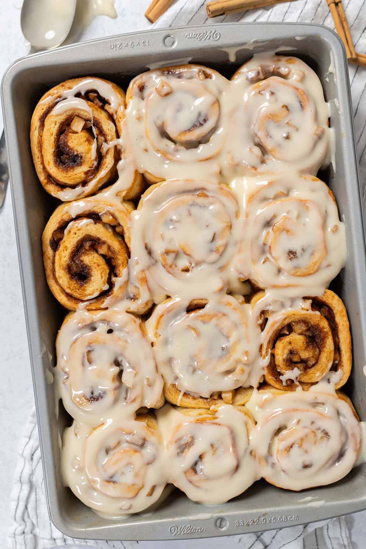 A tray of baked apple cinnamon rolls.