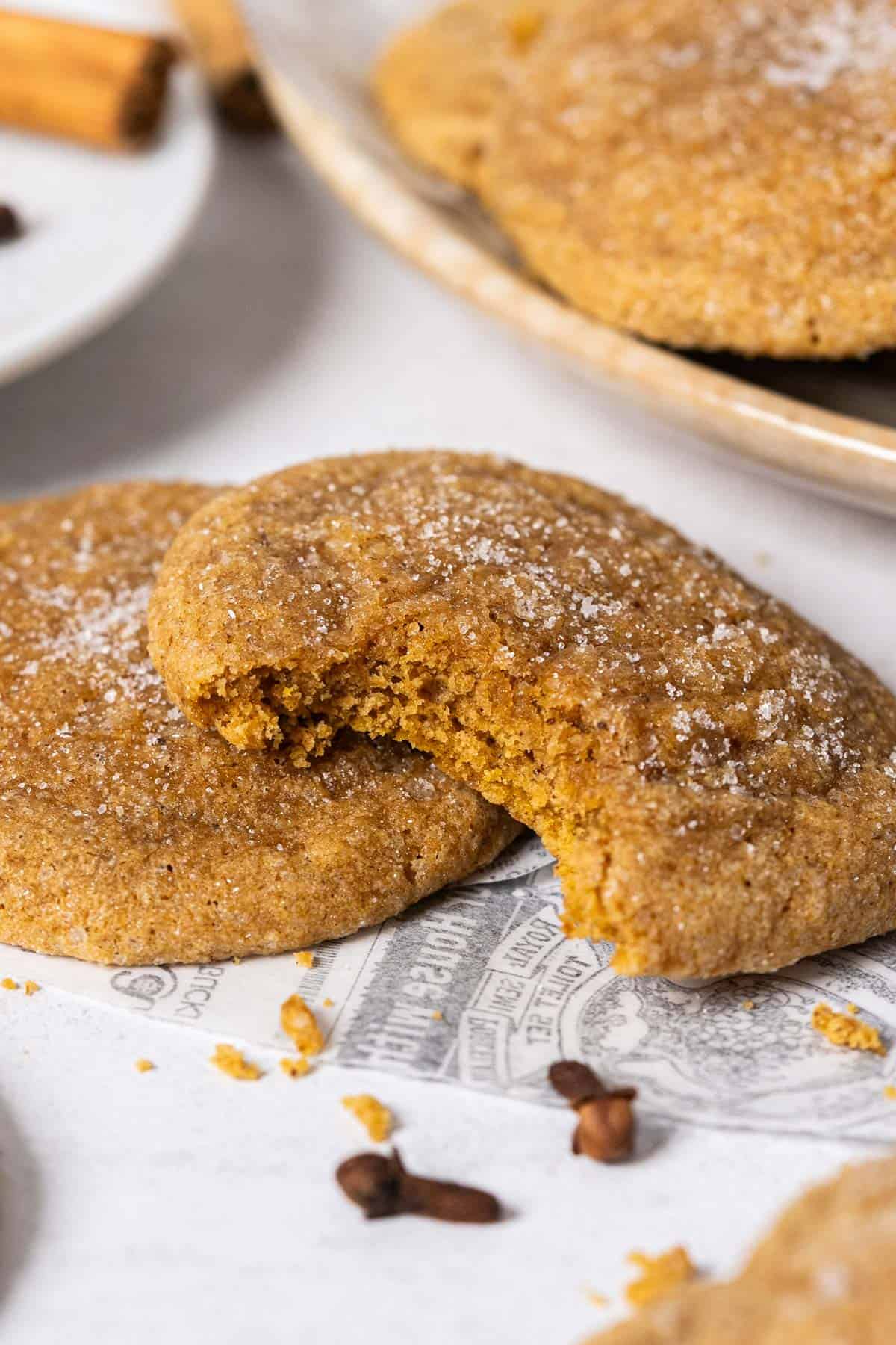 Half-eaten piece of chewy pumpkin cookie.