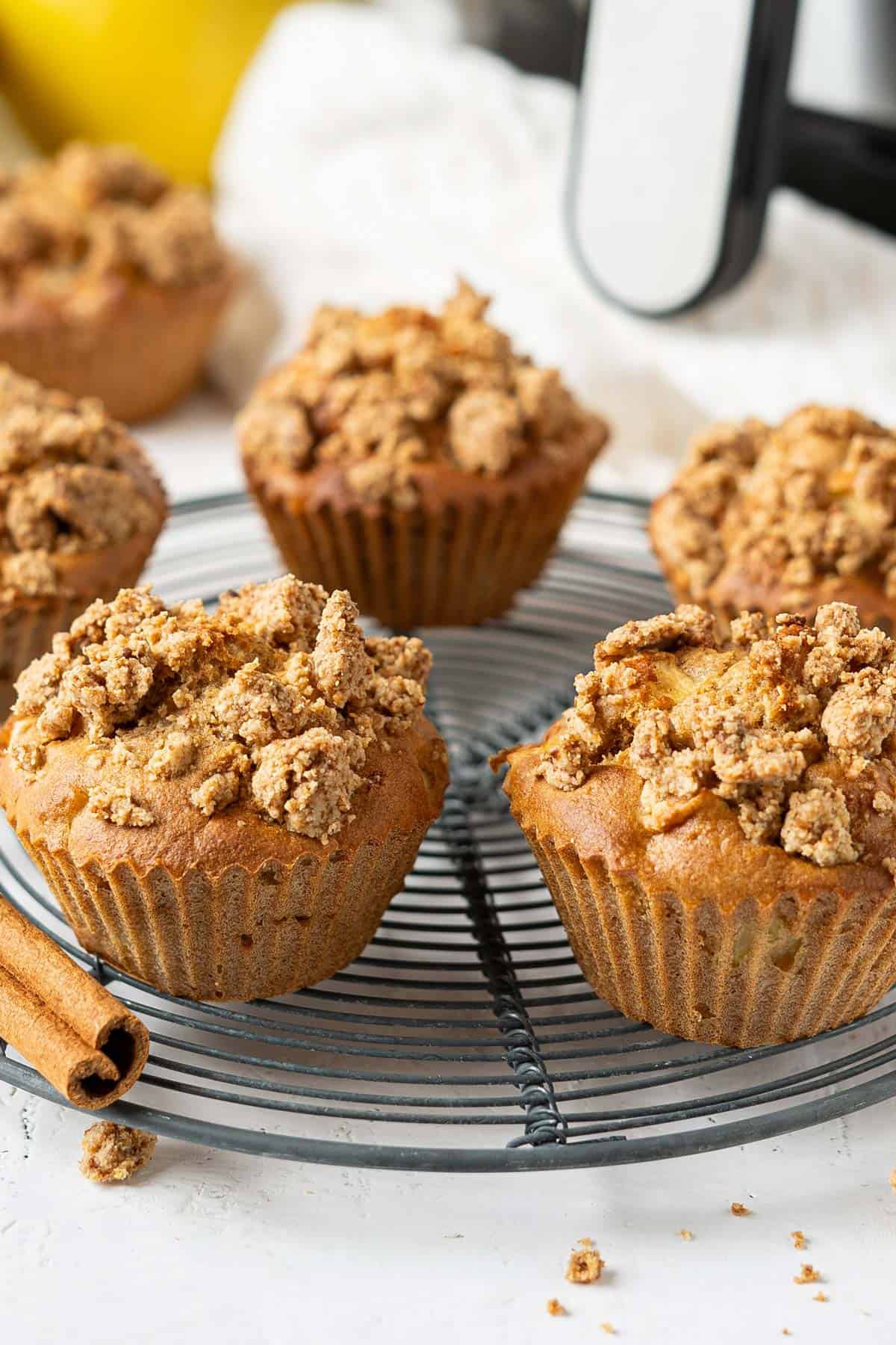 Several muffins on a rack.