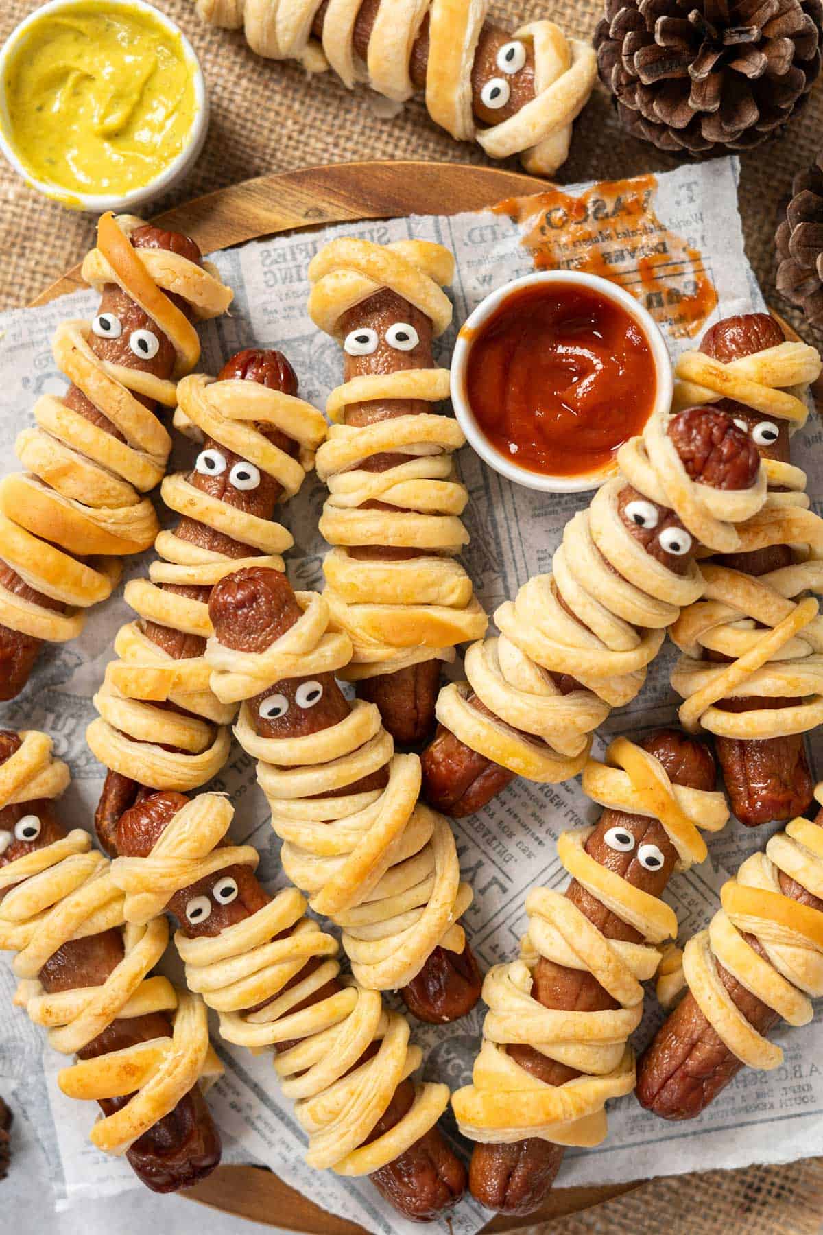 A plate Halloween mummies with dipping sauces.