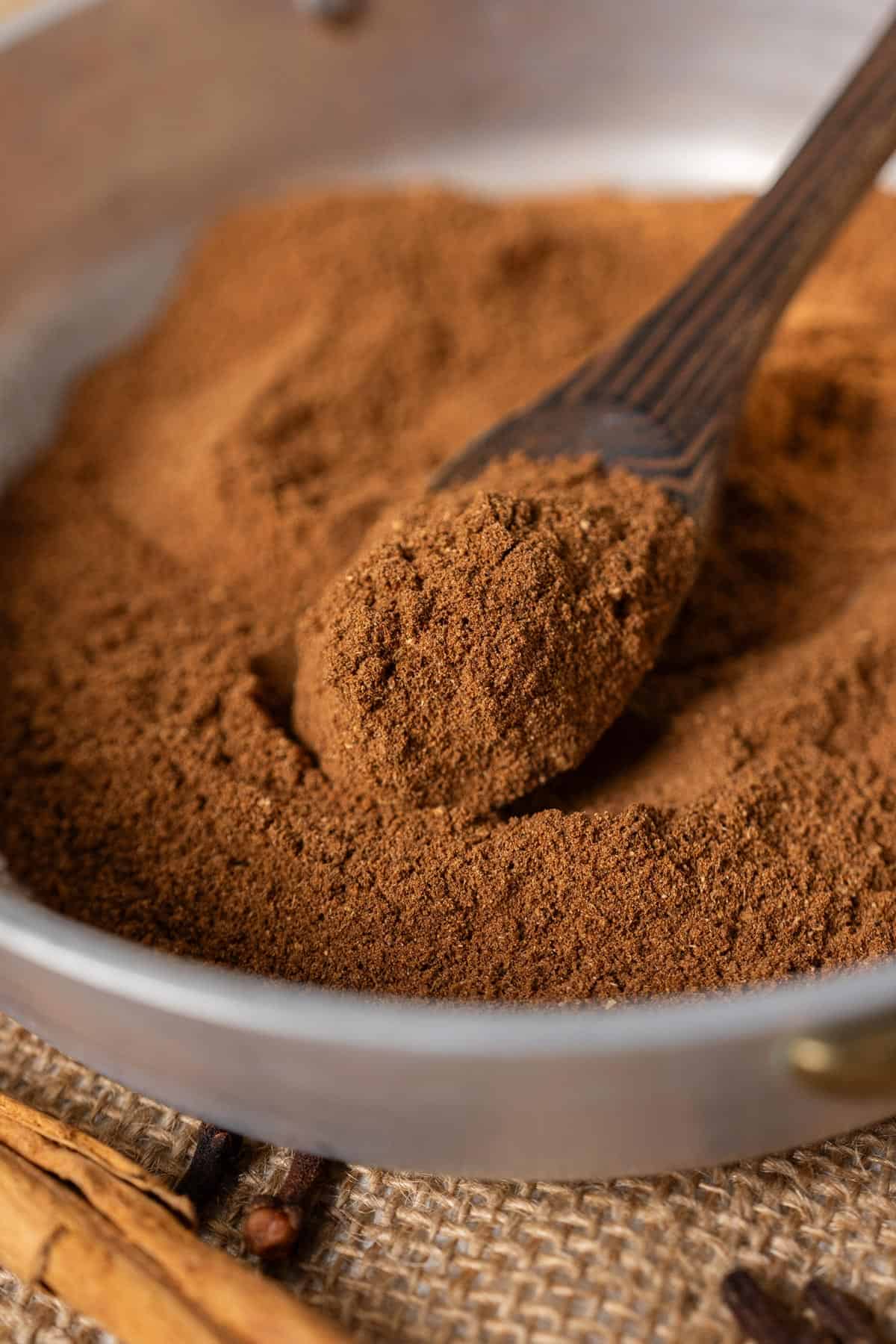 Spooning pumpkin pie spice.