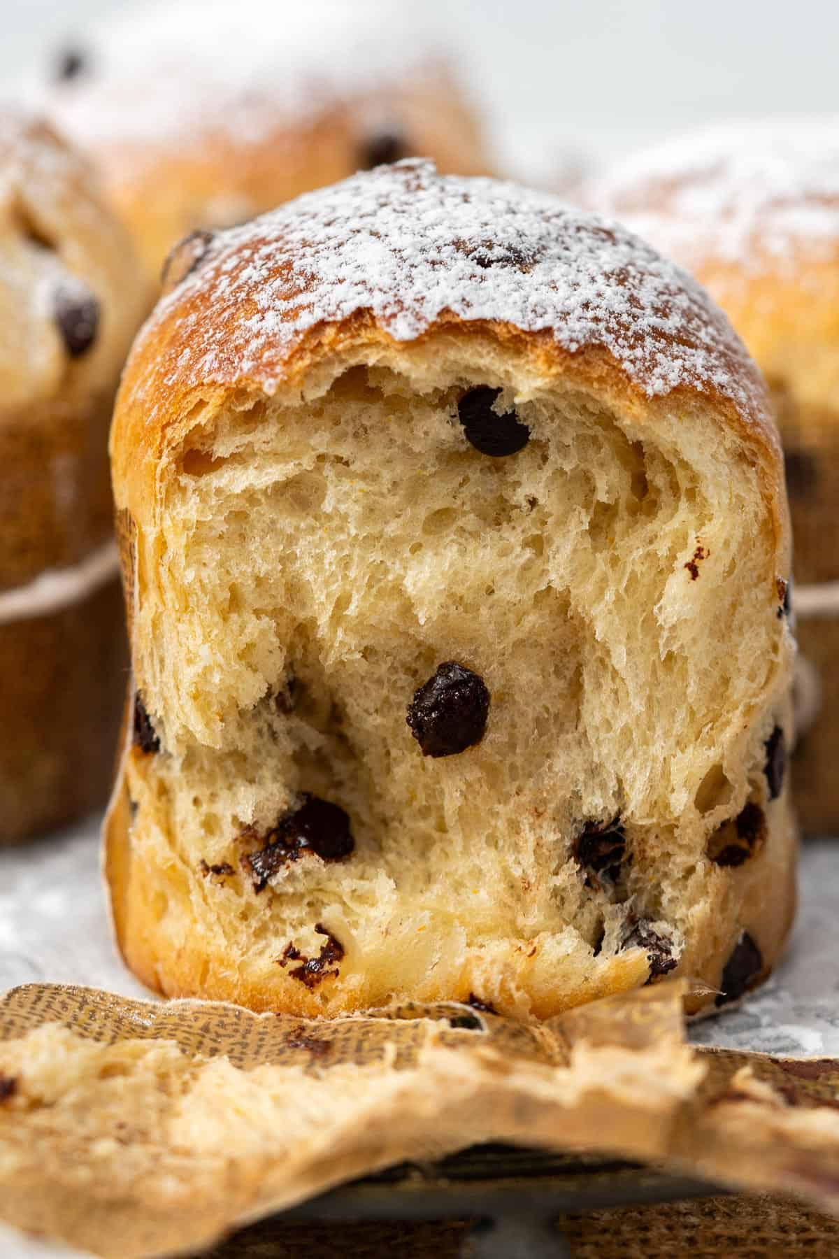 Showing the inside texture of a mini panettone with chocolate chips.