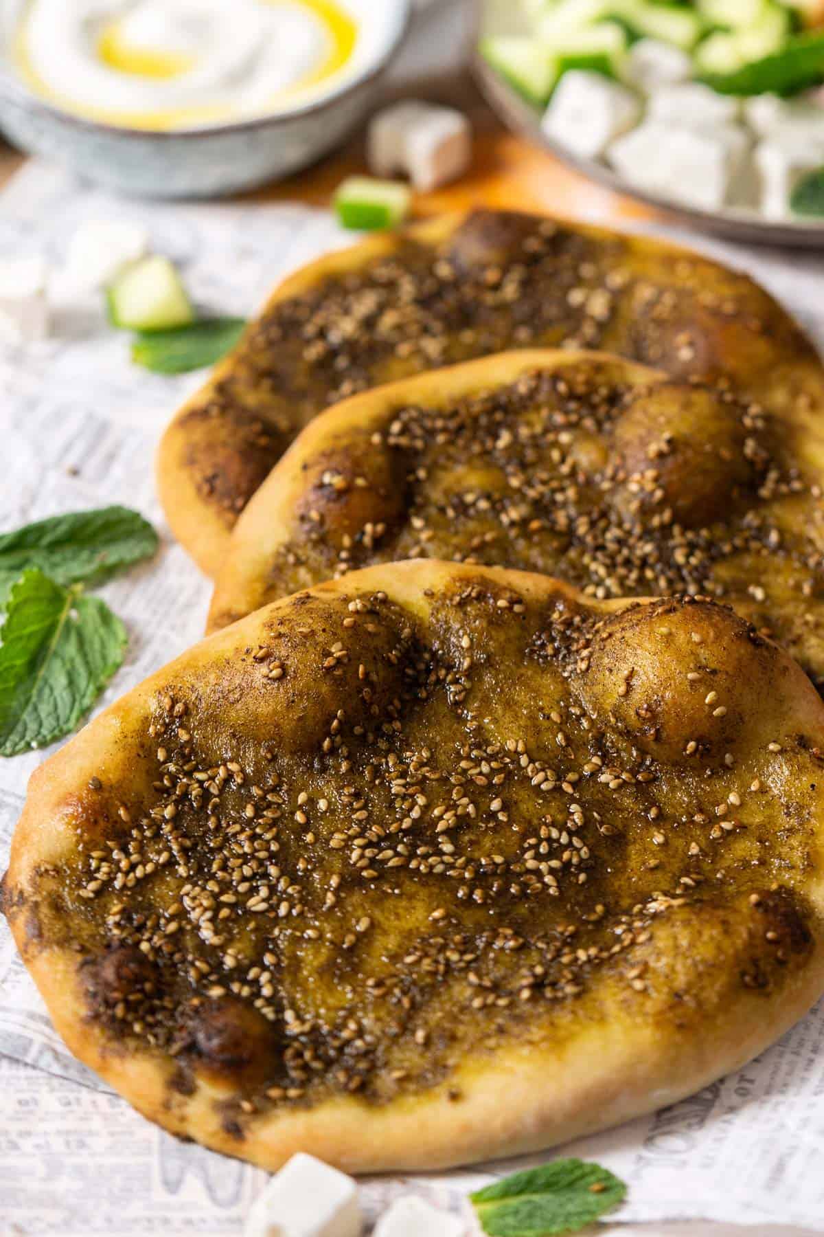 Three manoushe zaatar flatbreads view from the front.