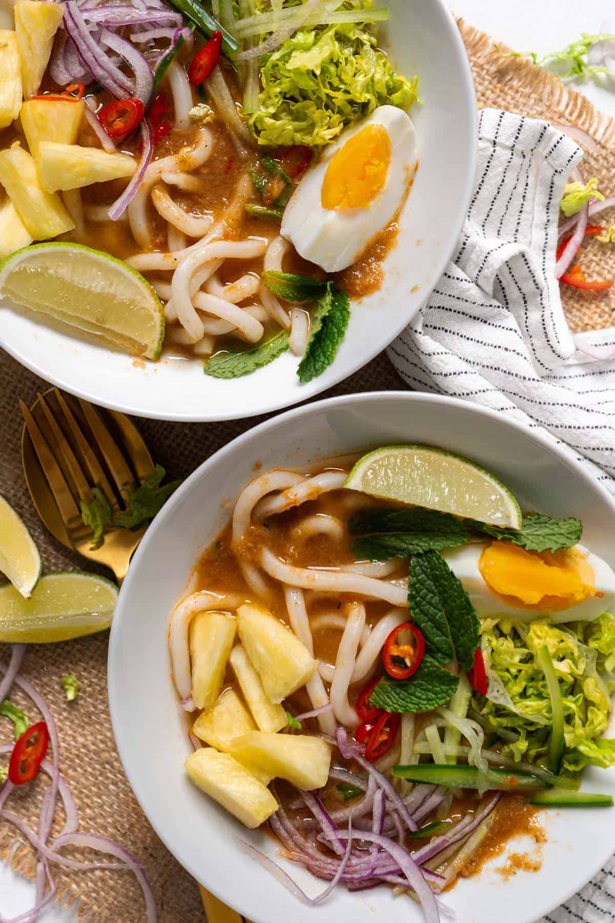 Assam laksa served in two small bowls.