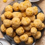 Cornflake cookies stacked on a cooling rack.