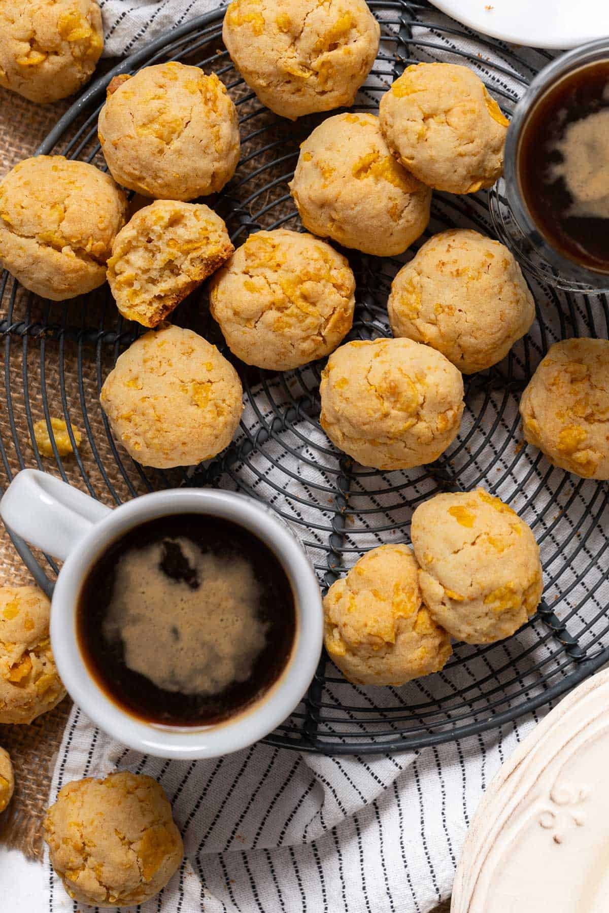 Cornflake cookies on a cooling rack with coffees.