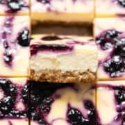 Close up of a slice of blueberry cheesecake bar.