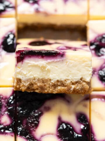Close up of a slice of blueberry cheesecake bar.