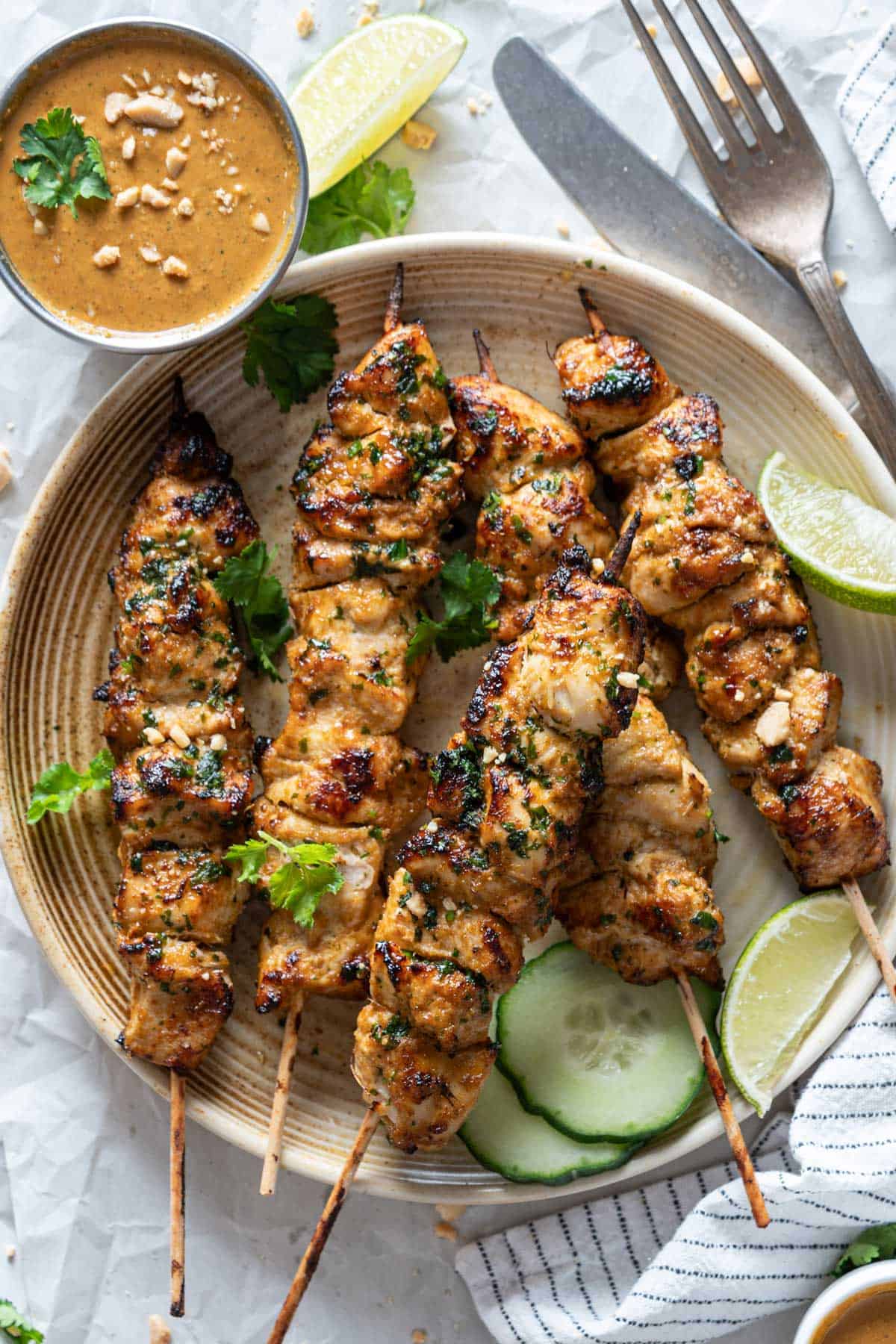 Air fryer chicken skewers with peanut sauce viewed from the top.