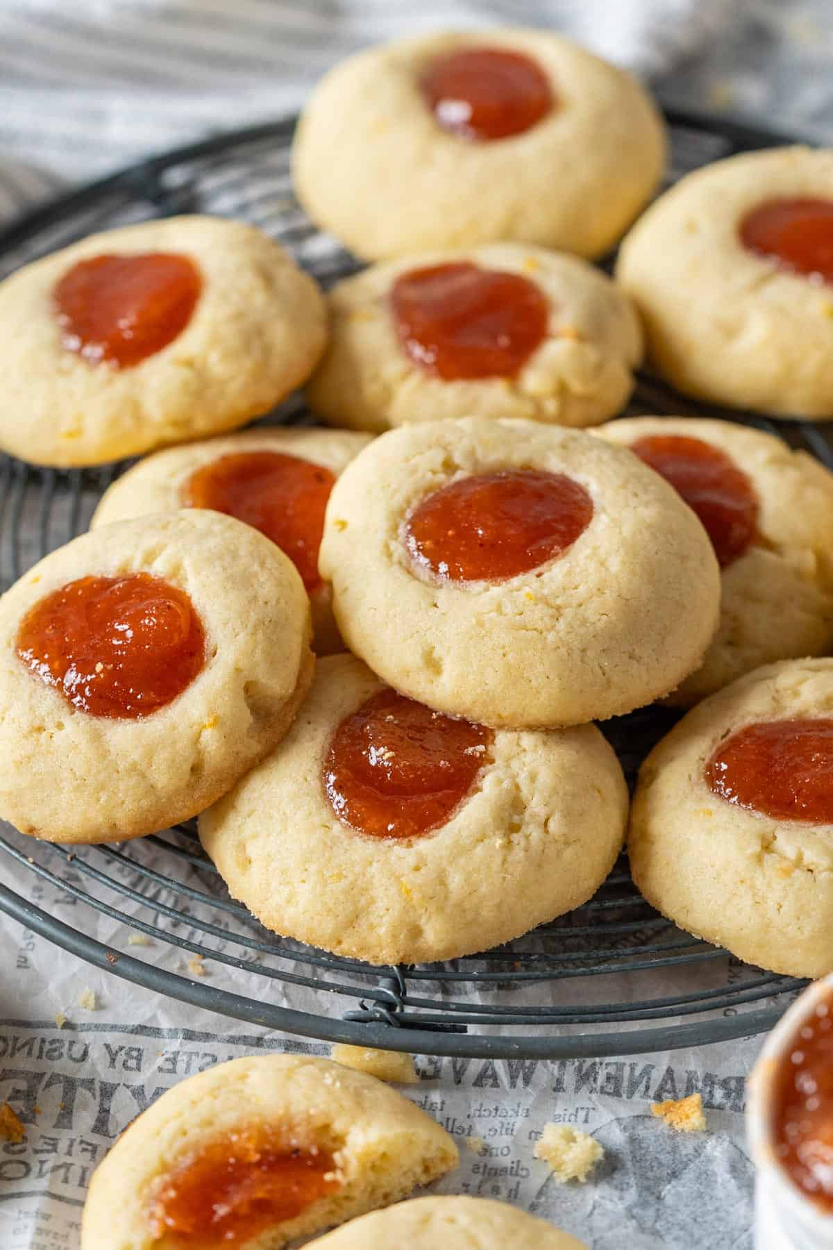 Close-up of thumbprint cookies on a cooling rack.