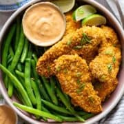 Air fryer bang bang chicken with green beans, view from top.