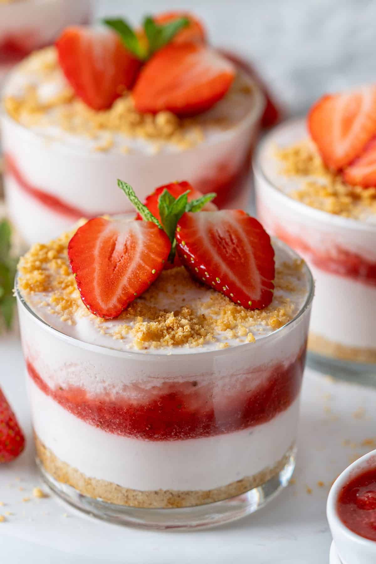 Three glasses of strawberry cheesecake.