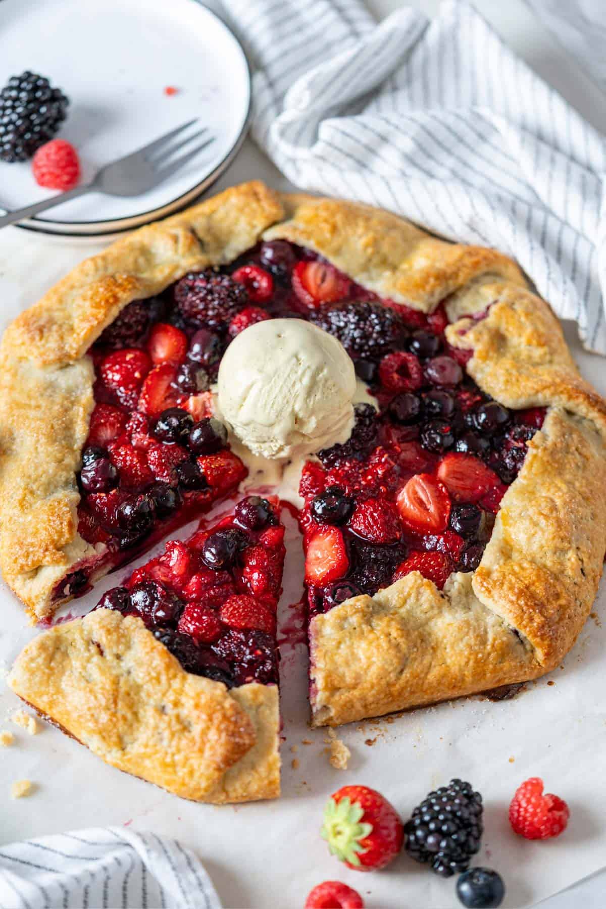 Berry galette with a scoop of vanilla ice cream.