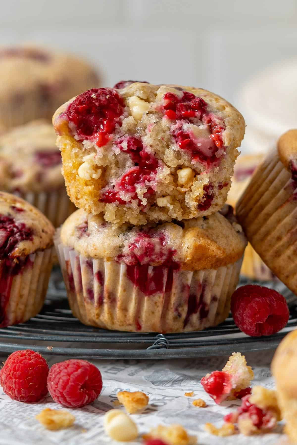 Raspberry and white chocolate muffins on a cooling rack.
