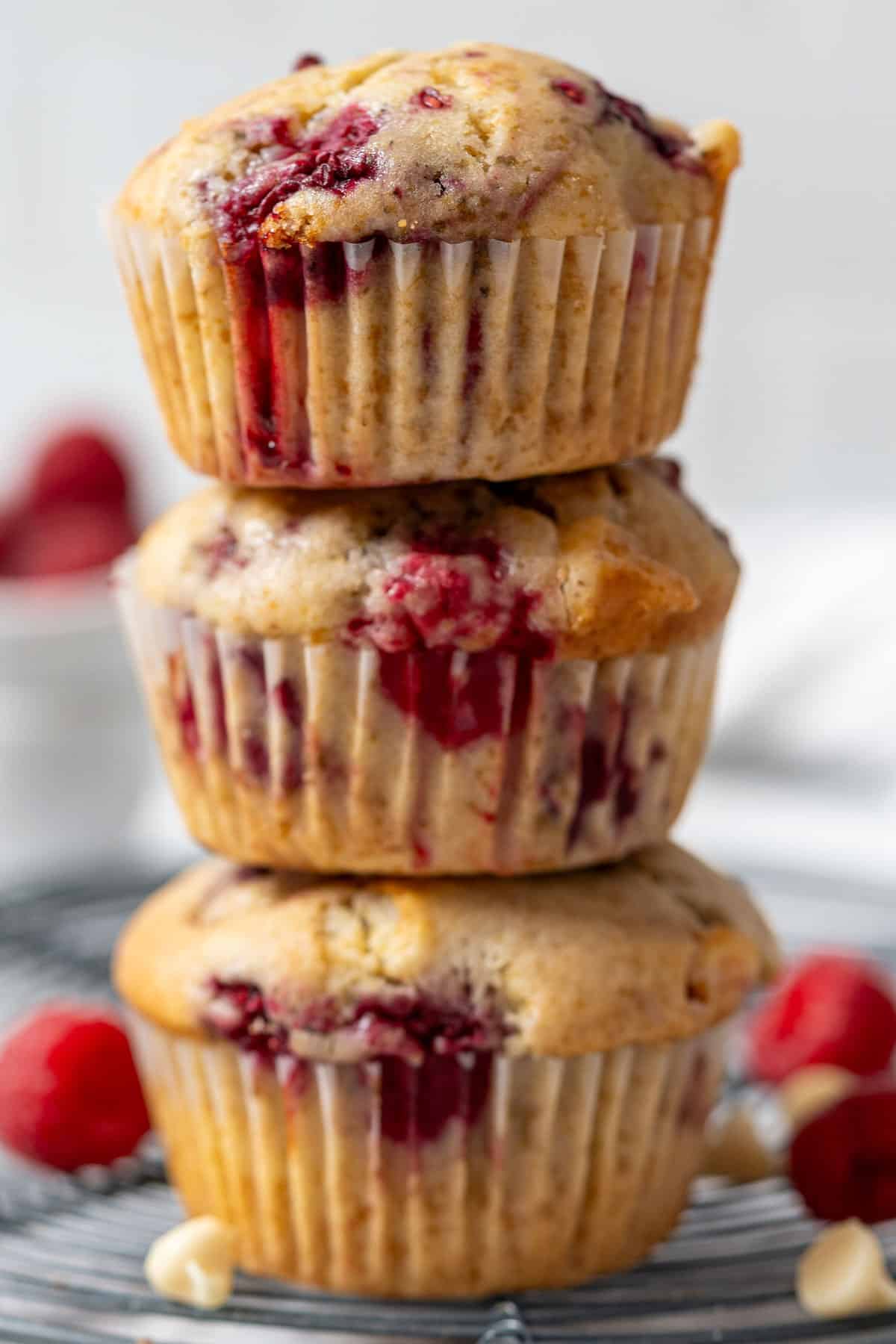 A stacked of raspberry and white chocolate muffins.