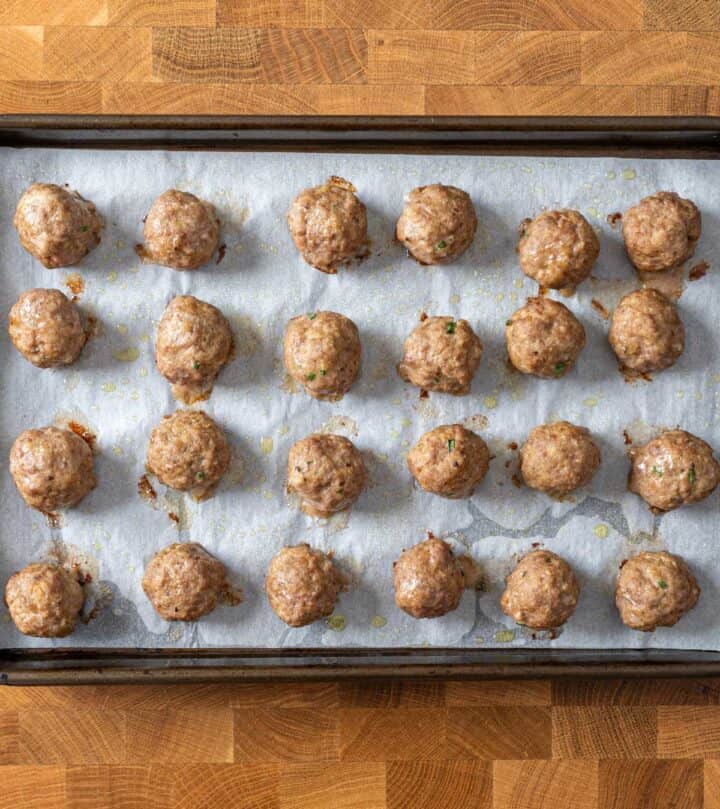 Baked meatballs on a tray.