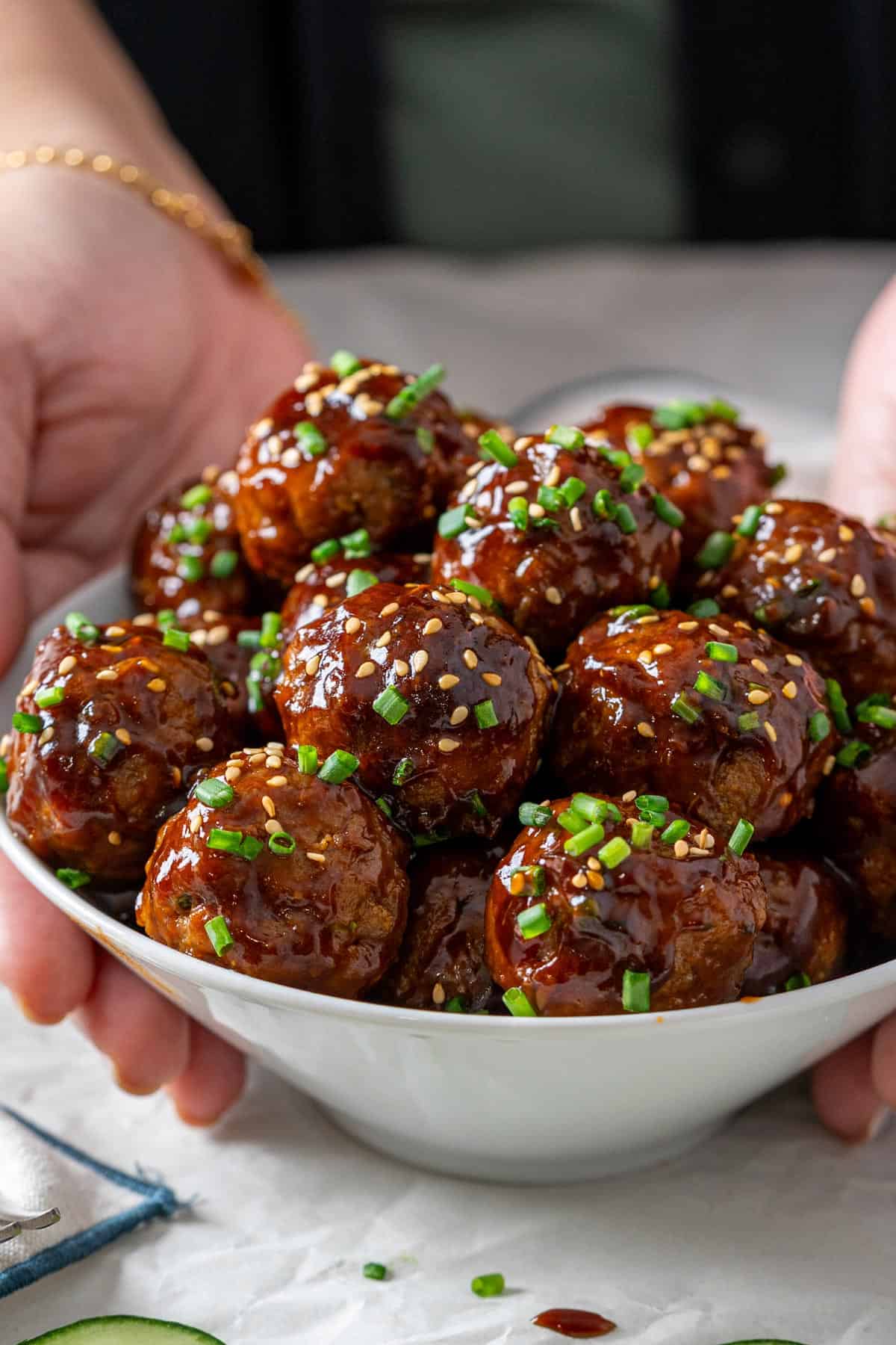 Holding a bowl of Korean meatballs.