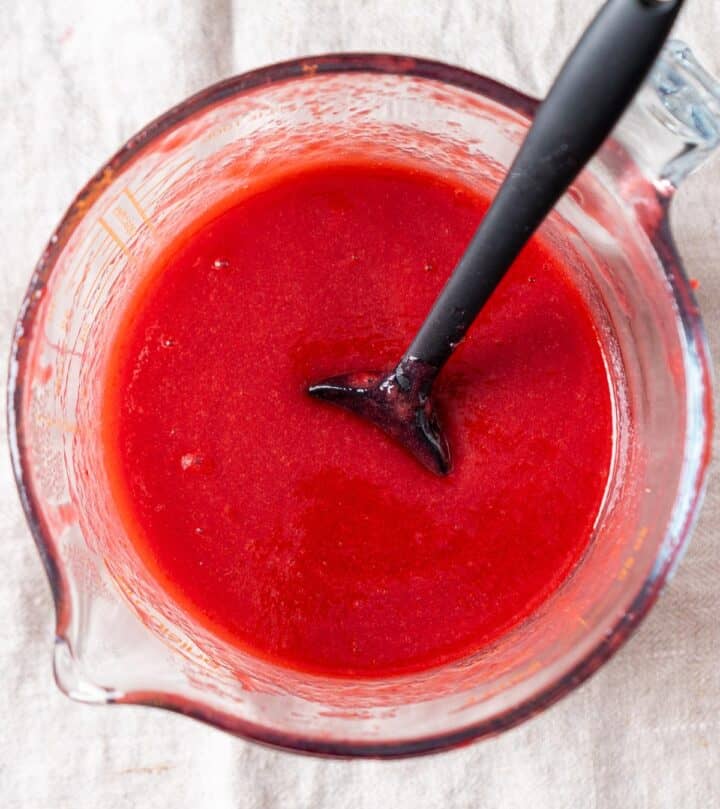 Raspberry coulis without seeds in a jar.