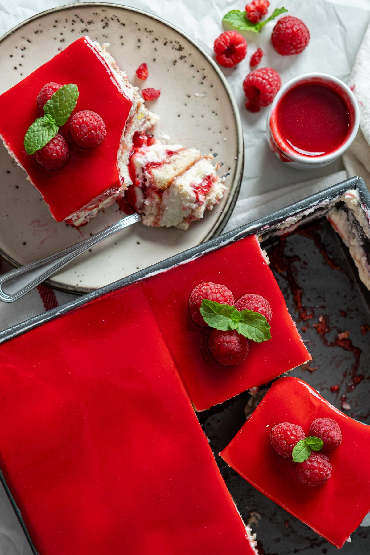 Raspberry tiramisu served in a plate and the balance is in the pan.