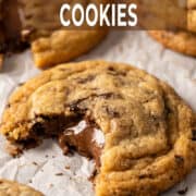 Nutella-stuffed cookies with chocolate chunks on parchment paper.