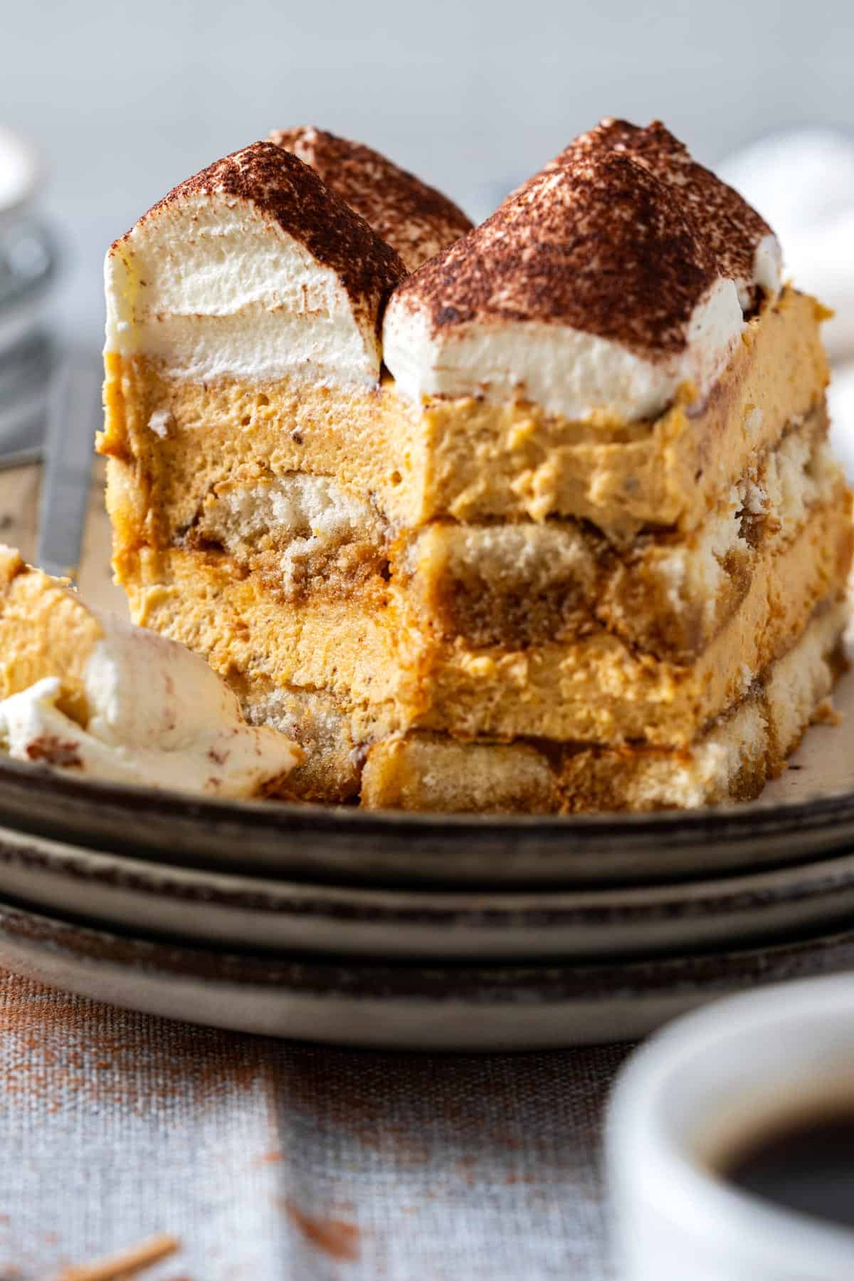 Showing the creamy texture of a slice of pumpkin tiramisu with a fork.