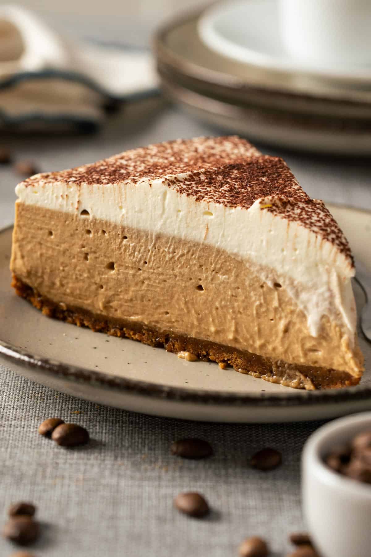 A slice of coffee cheesecake on a plate.