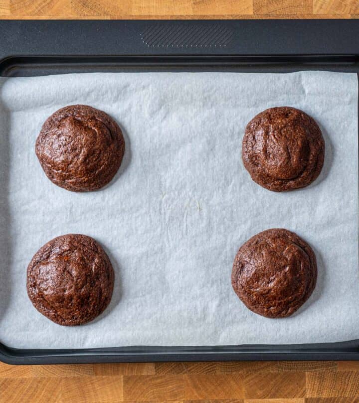Baked peanut butter stuffed chocolate cookies on a tray.