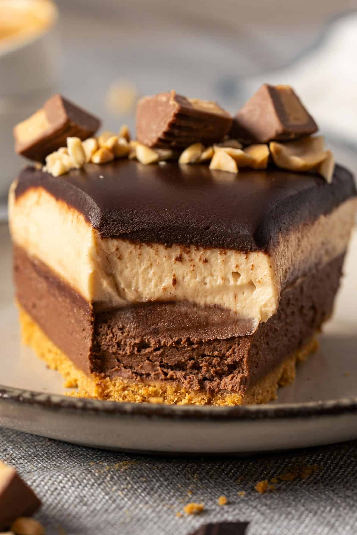 Half eaten slice of no bake peanut butter chocolate cheesecake.